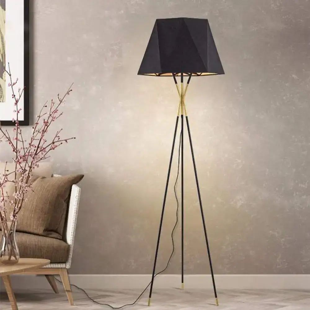 Tripod floor lamp with black shade and gold accents in living room setting on Tampa Home & Garden Store