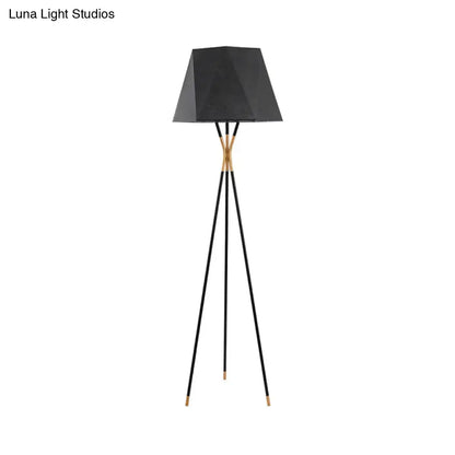 Tripod floor lamp with angular black shade and gold-tone joints on Tampa Home & Garden Store
