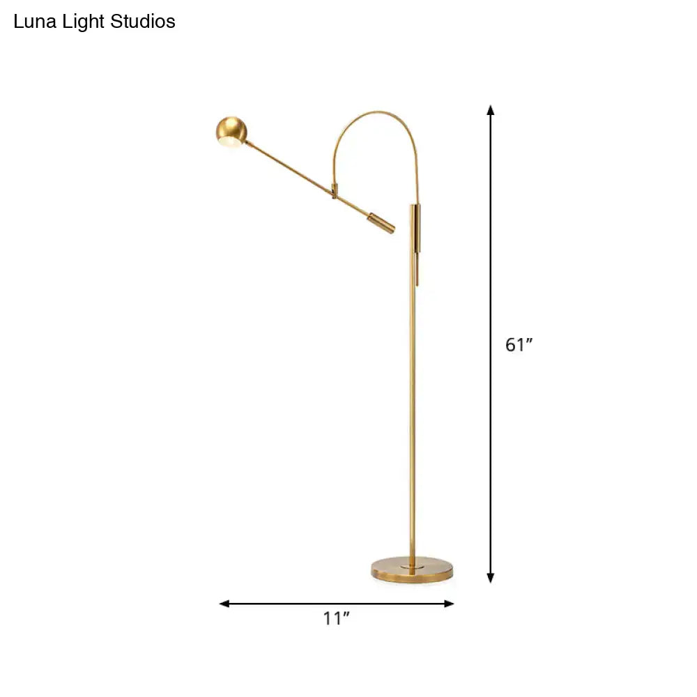 Gold arc floor lamp with adjustable arm and round base on Tampa Home & Garden Store