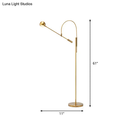 Gold arc floor lamp with adjustable arm and round base on Tampa Home & Garden Store