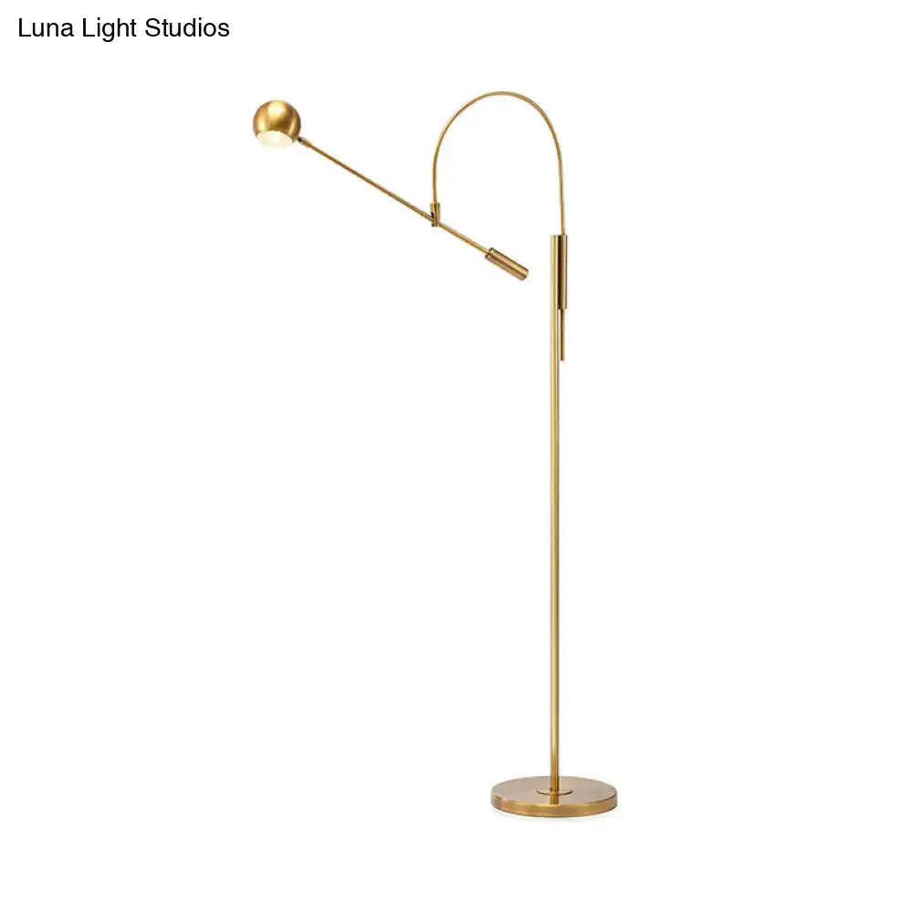 Gold floor lamp with adjustable brass arm and round base on Tampa Home & Garden Store