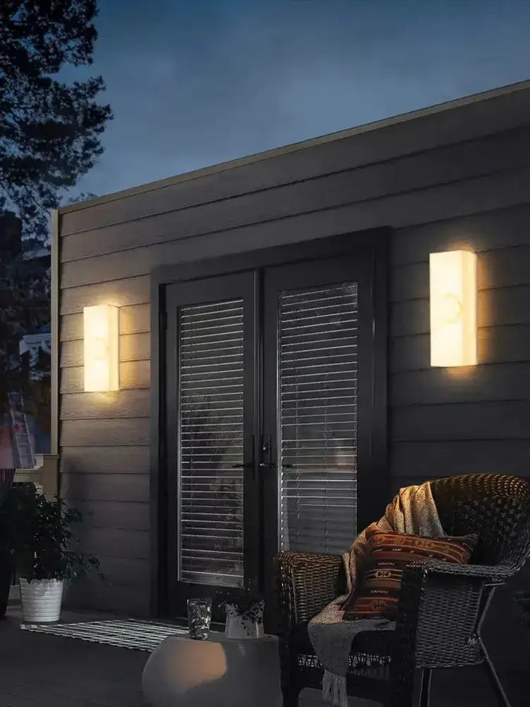 Modern onyx amber geometric LED outdoor wall sconce pair warm glow on dark siding Decorbites on Tampa Home & Garden Store