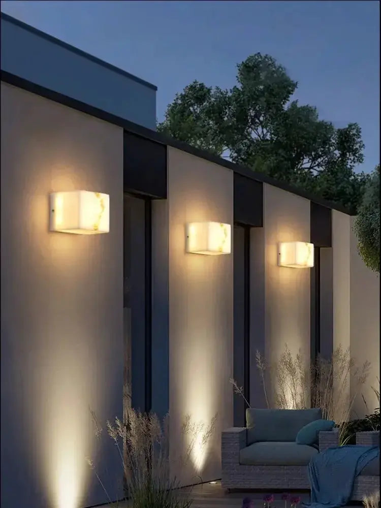 Modern onyx amber geometric LED outdoor wall sconce set of three on an exterior wall on Tampa Home & Garden Store