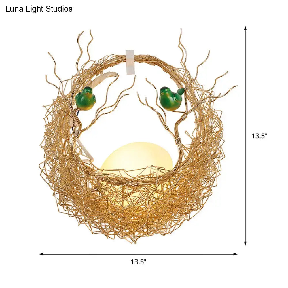 Opal Glass Bird Nest Sconce by Decorbites, gold wire nest with green birds, warm glow on Tampa Home & Garden Store
