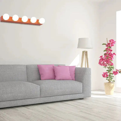 3-bulb vanity light fixture, orange and white, Decorbites, wall-mounted above a gray sofa on Tampa Home & Garden Store