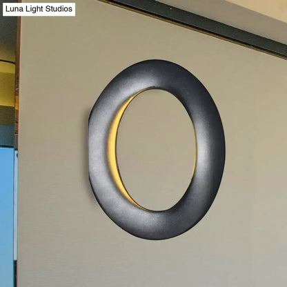 Black LED aluminum circline wall light with warm inner ring glow by Decorbites on beige wall on Tampa Home & Garden Store