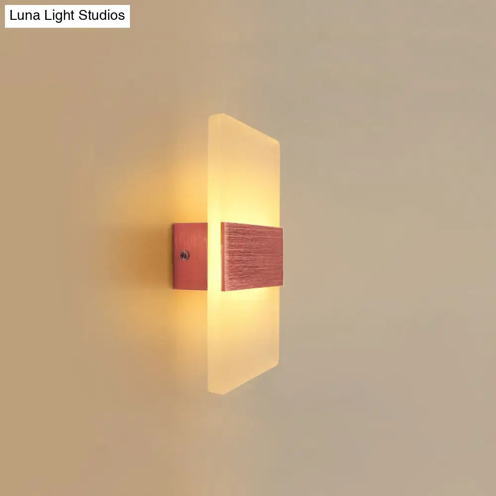 Metal oval LED wall sconce with frosted panel and wood mount, warm glow on Tampa Home & Garden Store