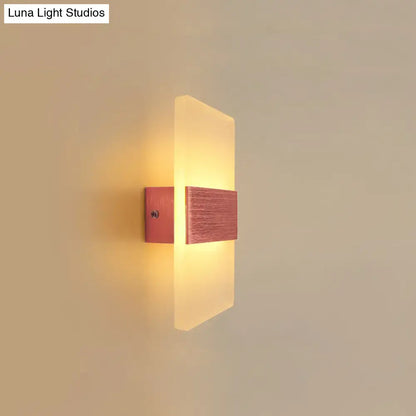 Metal oval LED wall sconce with frosted panel and wood mount, warm glow on Tampa Home & Garden Store