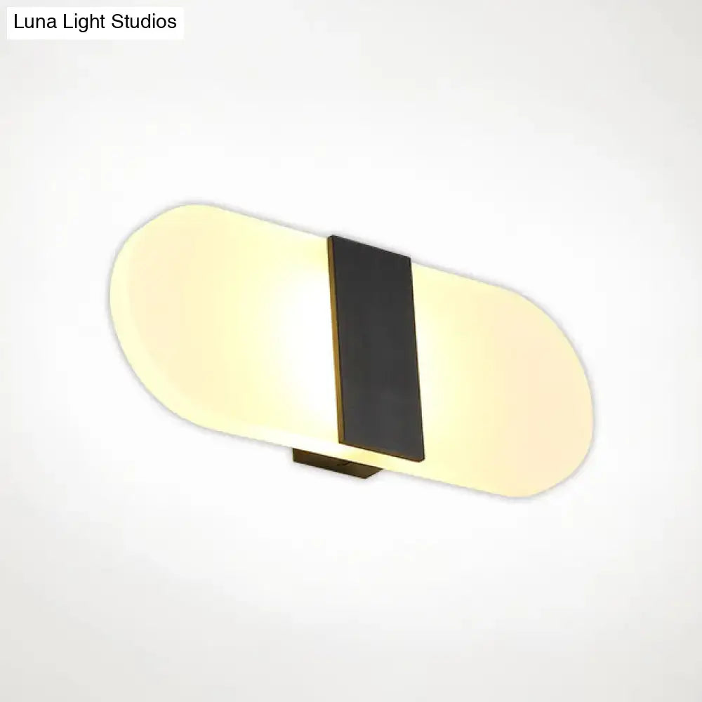 Metal Oval LED Sconce by Decorbites, black vertical stripe with warm backlit oval panels on Tampa Home & Garden Store