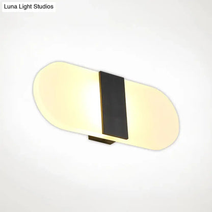 Metal Oval LED Sconce by Decorbites, black vertical stripe with warm backlit oval panels on Tampa Home & Garden Store