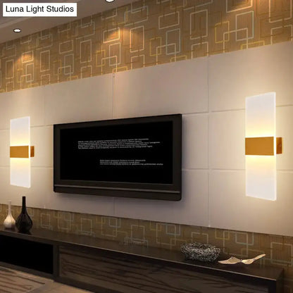 Metal oval LED wall sconce by Decorbites with frosted white panels and gold band, flanking a TV on Tampa Home & Garden Store