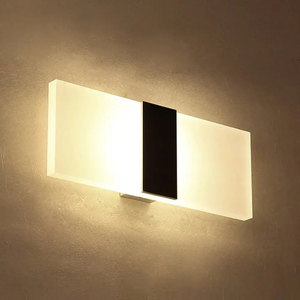 Metal Oval LED Sconce by Decorbites with black center panel and warm white glow on Tampa Home & Garden Store