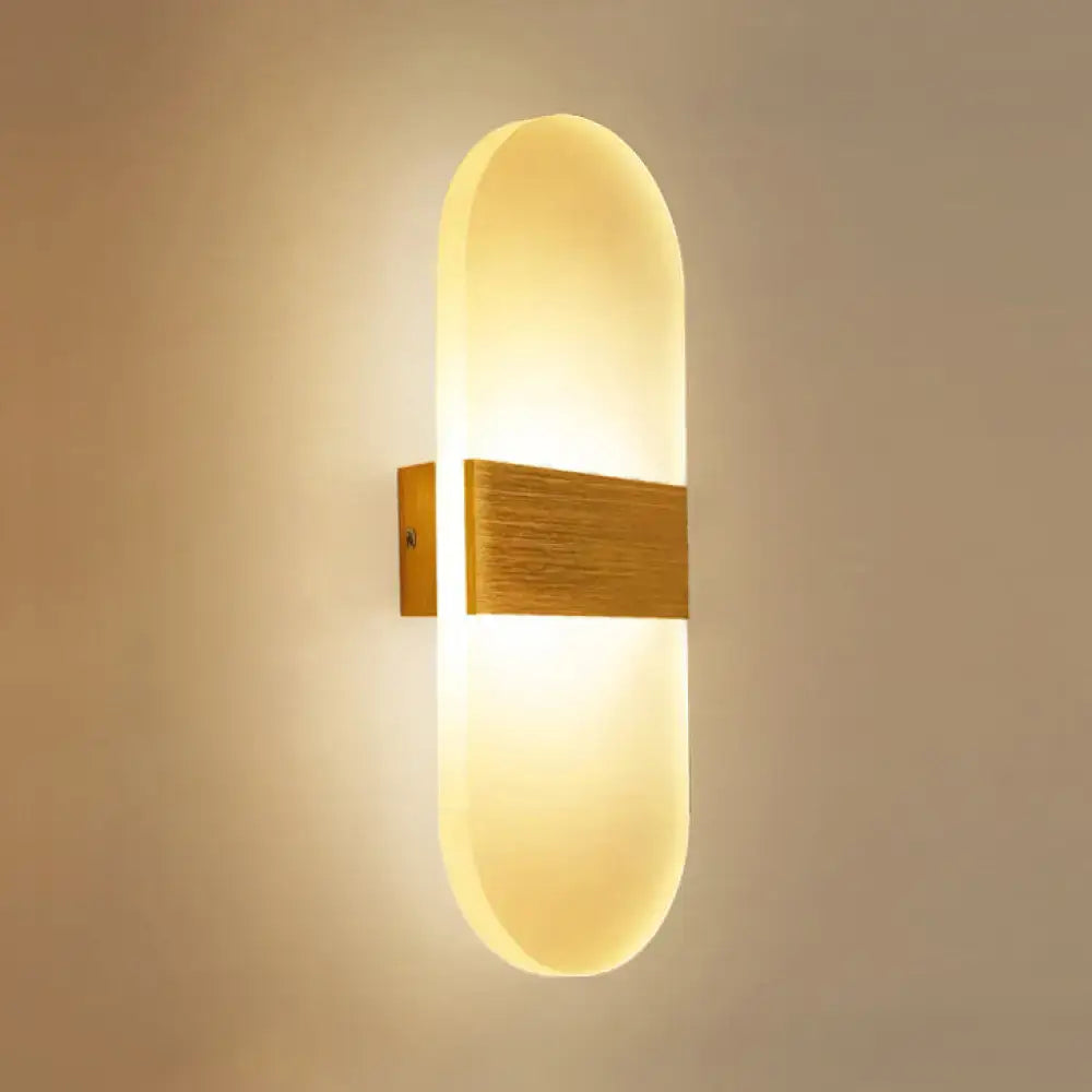 Metal Oval LED Sconce Decorbites with warm wood mounting and diffused glow on Tampa Home & Garden Store
