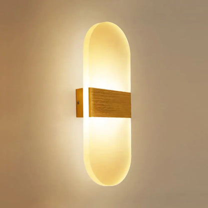 Metal Oval LED Sconce Decorbites with warm wood mounting and diffused glow on Tampa Home & Garden Store