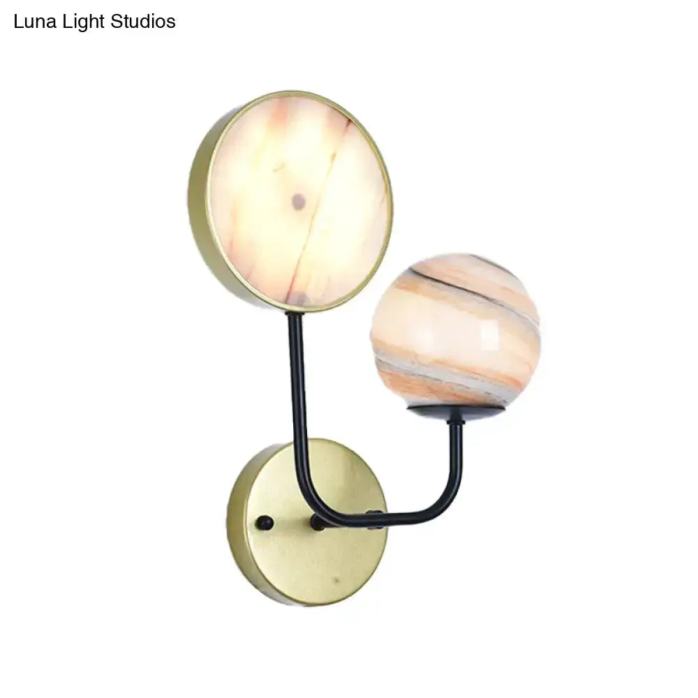Decorbites two-globe peach and cream glass sconce with brass backplate and black curved arm on Tampa Home & Garden Store