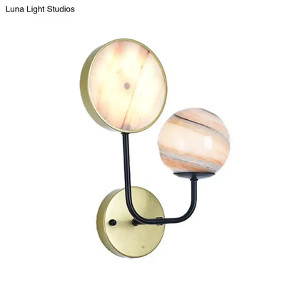 Decorbites two-globe peach and cream glass sconce with brass backplate and black curved arm on Tampa Home & Garden Store