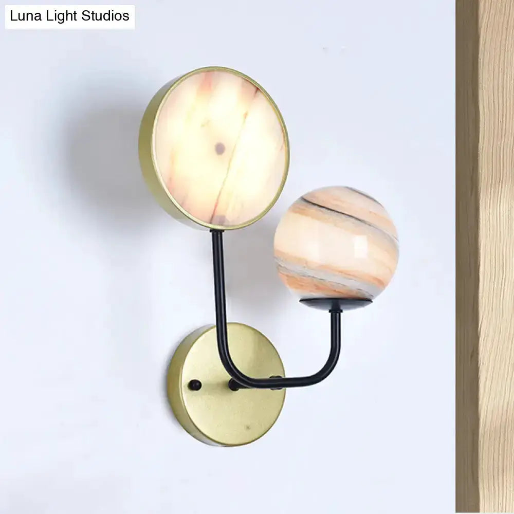 Modern peach and cream glass double sconce with brass backplate and black arm, two orb shades on Tampa Home & Garden Store