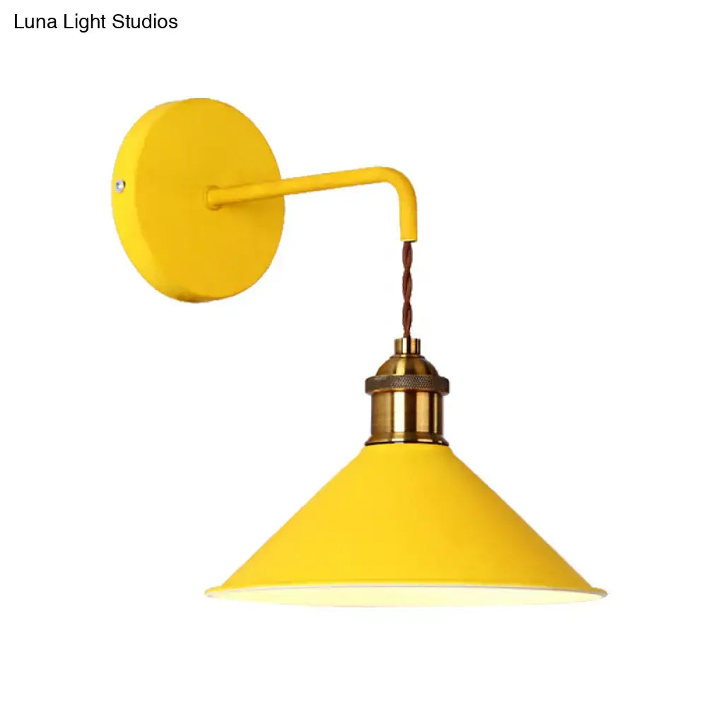 Yellow conical metal wall sconce with brass socket and twisted cord on Tampa Home & Garden Store