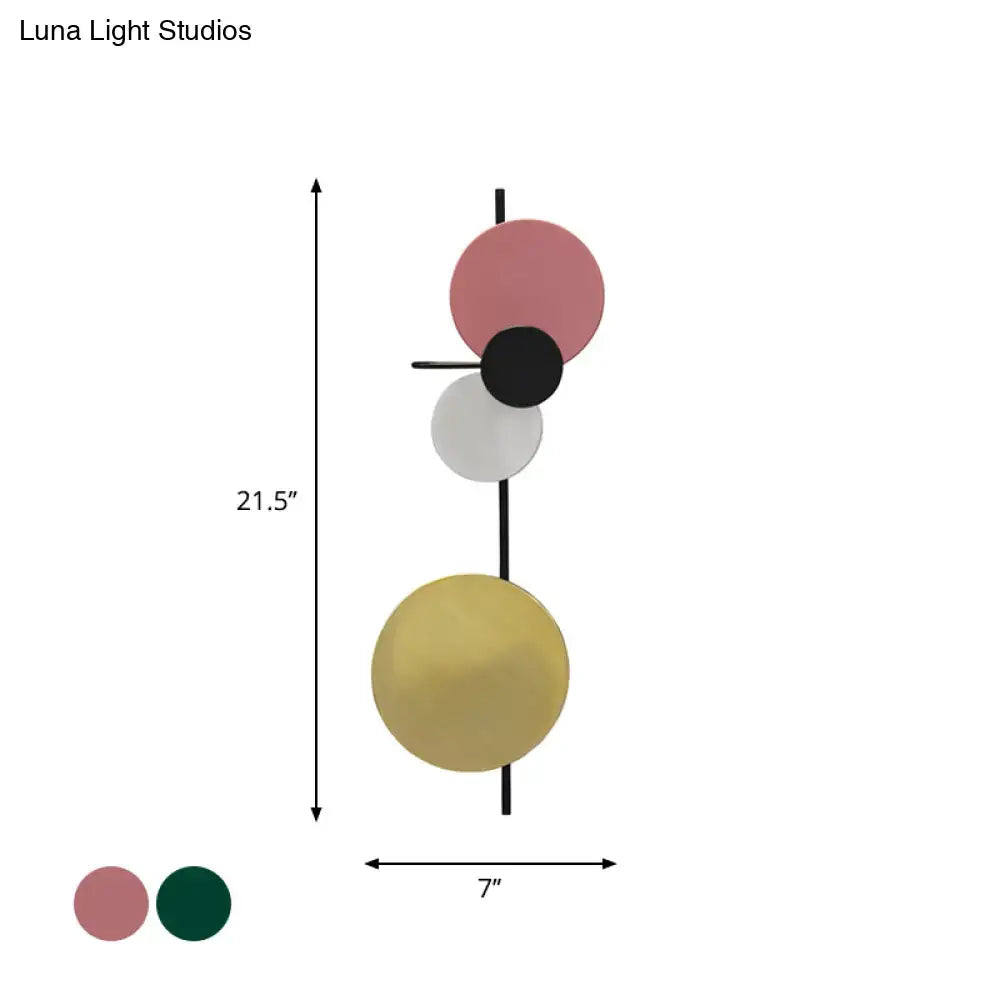 Pink gold circular wall light by Decorbites with stacked discs on a black rod on Tampa Home & Garden Store