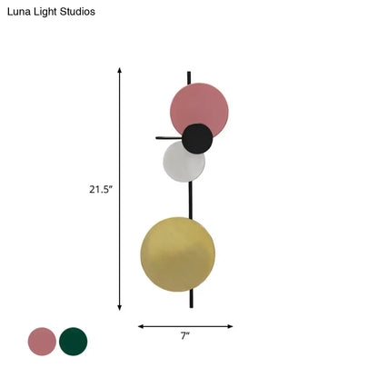 Pink gold circular wall light by Decorbites with stacked discs on a black rod on Tampa Home & Garden Store