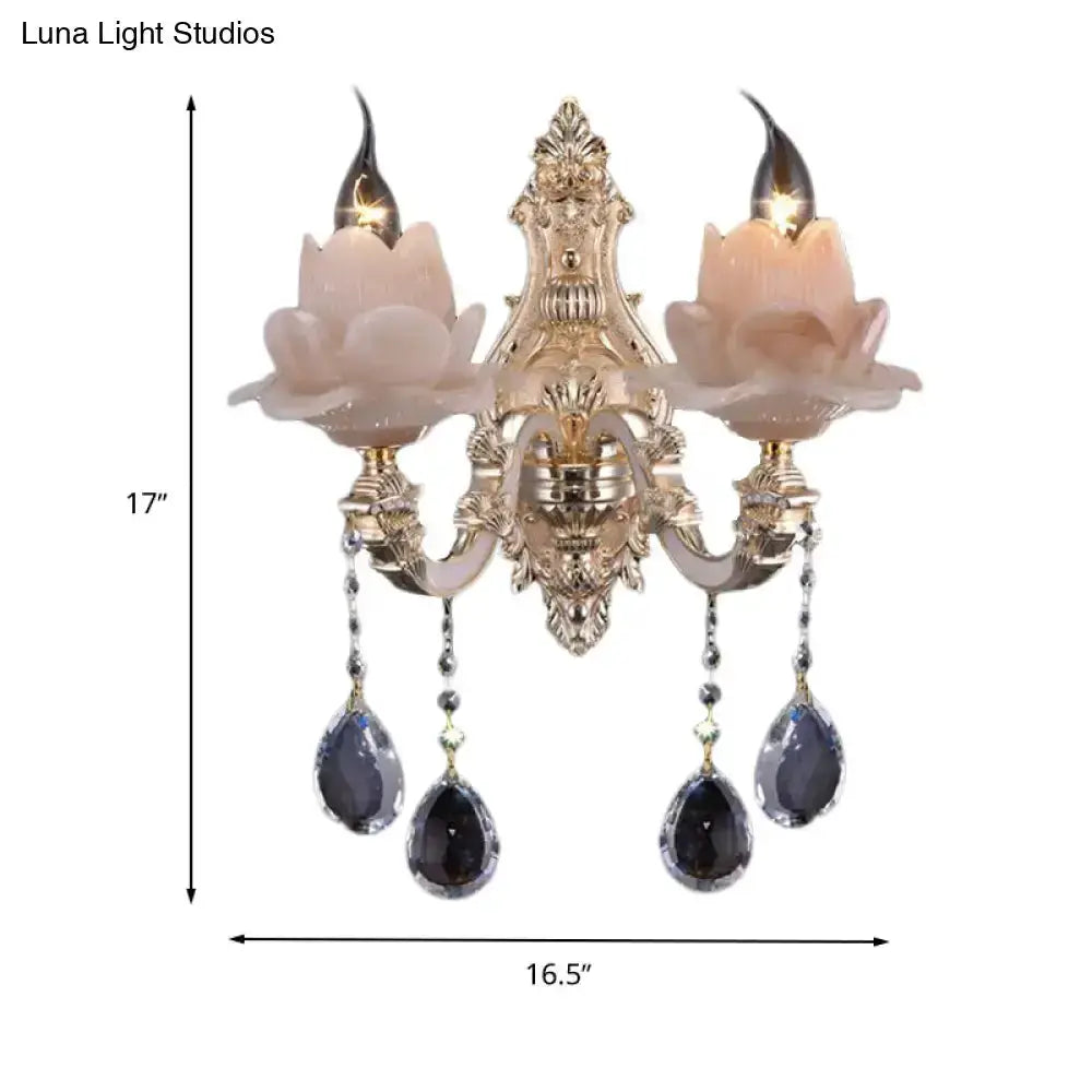 Modern pink lotus wall lamp with teardrop crystals, two candle bulbs, ornate gold backplate on Tampa Home & Garden Store
