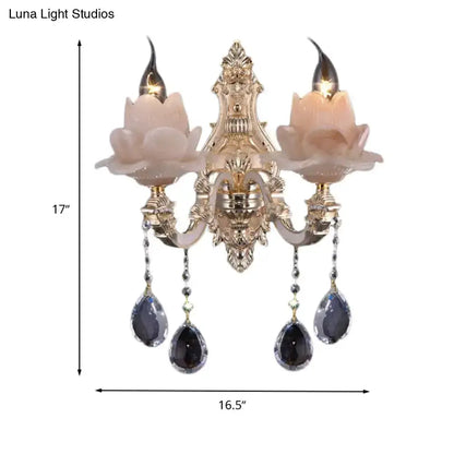 Modern pink lotus wall lamp with teardrop crystals, two candle bulbs, ornate gold backplate on Tampa Home & Garden Store