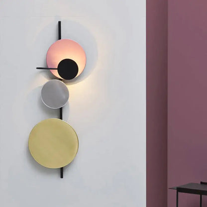 Pink Circular Wall Light by Decorbites; disc sculpture with four colored circles on a black rod on Tampa Home & Garden Store