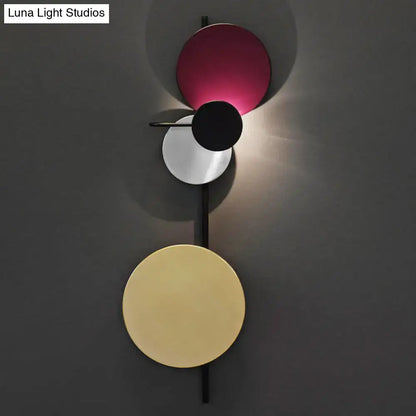 Pink circular wall light by Decorbites with stacked colored discs on a vertical black stem on Tampa Home & Garden Store