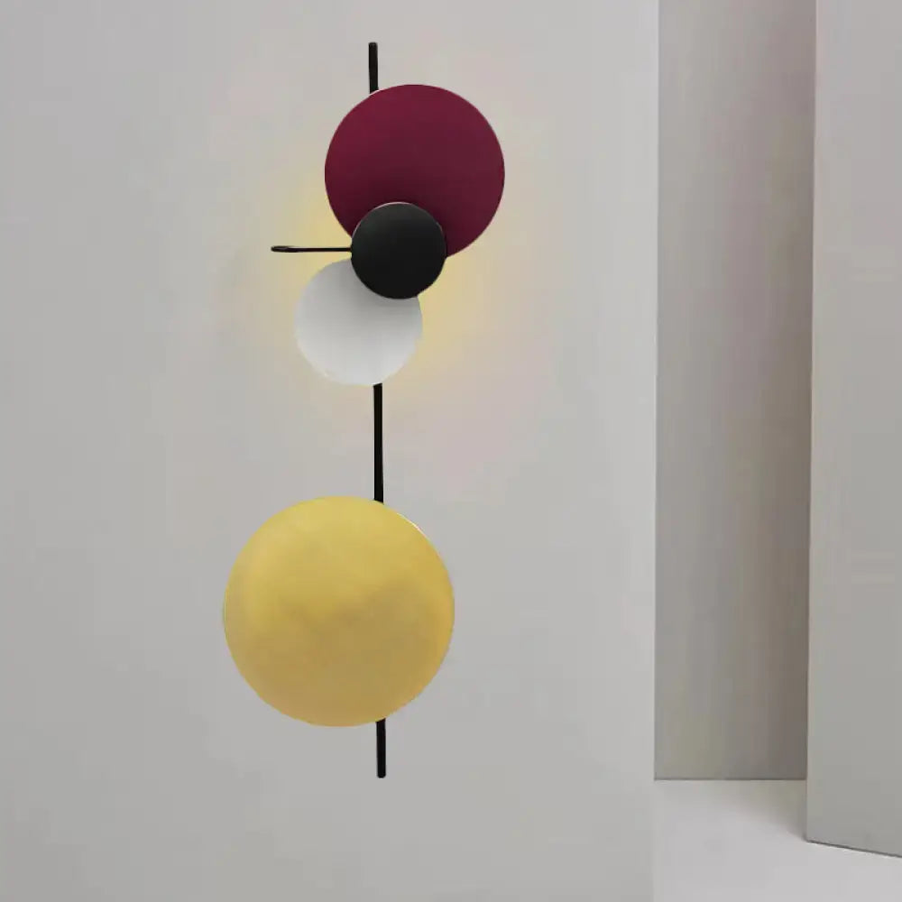 Pink circular wall light with stacked discs on a vertical rod Decorbites on Tampa Home & Garden Store