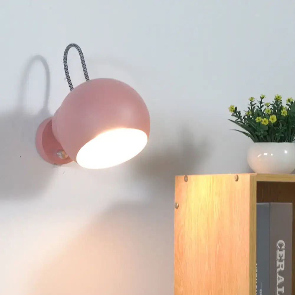 Pink spherical wall lamp by Decorbites, pink ceramic globe with curved arm, warm glow on Tampa Home & Garden Store