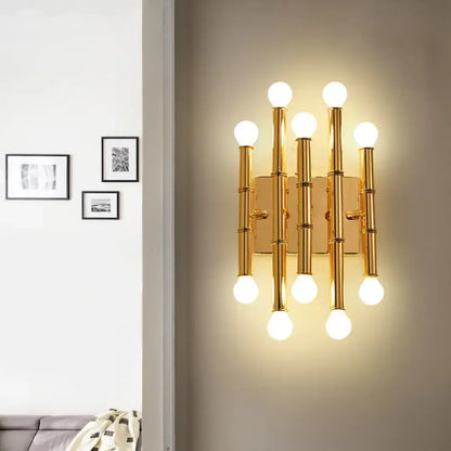 Gold bamboo wall sconce with eight globe bulbs on vertical bamboo rods on Tampa Home & Garden Store