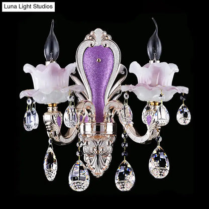 Crystal floral wall sconce with purple center panel and hanging crystal prisms by Decorbites on Tampa Home & Garden Store