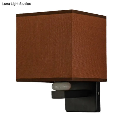 Fabric rectangle wall light with brown shade and black metal mount, white bulb visible on Tampa Home & Garden Store