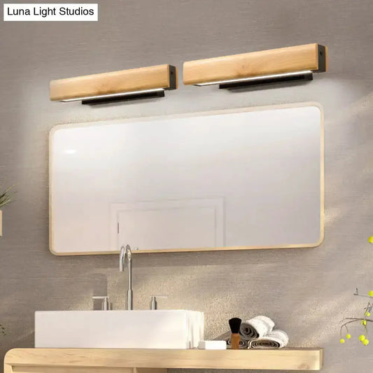 Pair of modern rectangular wood LED bathroom vanity sconces above a large mirror on Tampa Home & Garden Store