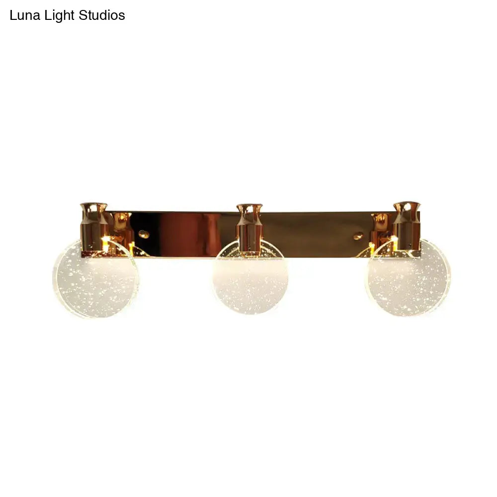 Rose gold globe vanity light by Decorbites with three speckled glass globes on a bar on Tampa Home & Garden Store