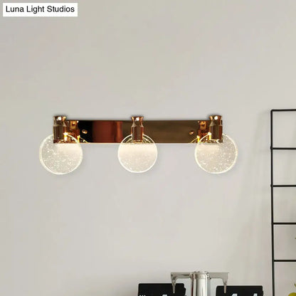 Rose gold globe vanity light fixture with three bubble glass globes on a sleek bar by Decorbites on Tampa Home & Garden Store