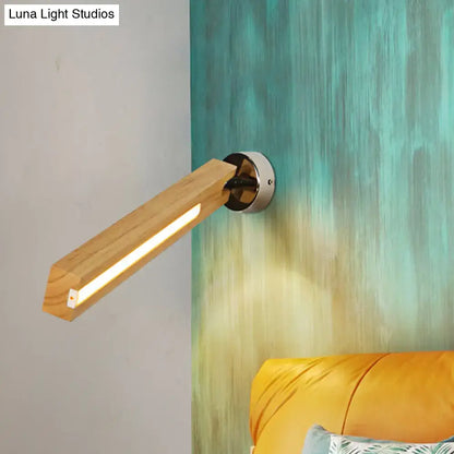 Beige wood wall light with horizontal wooden arm and metal round mount, warm LED glow on Tampa Home & Garden Store