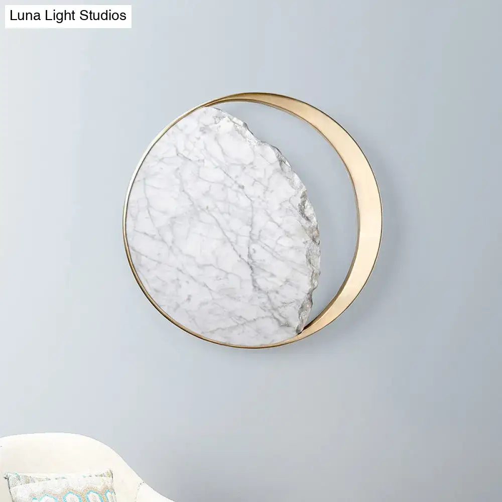 White marble wall sconce from Decorbites with brass ring and ambient LED glow on Tampa Home & Garden Store