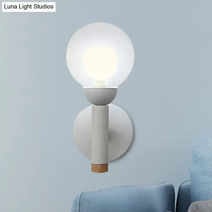 Sage Macaron Wall Sconce by Decorbites; white metal mount, frosted glass globe, wood accent on Tampa Home & Garden Store