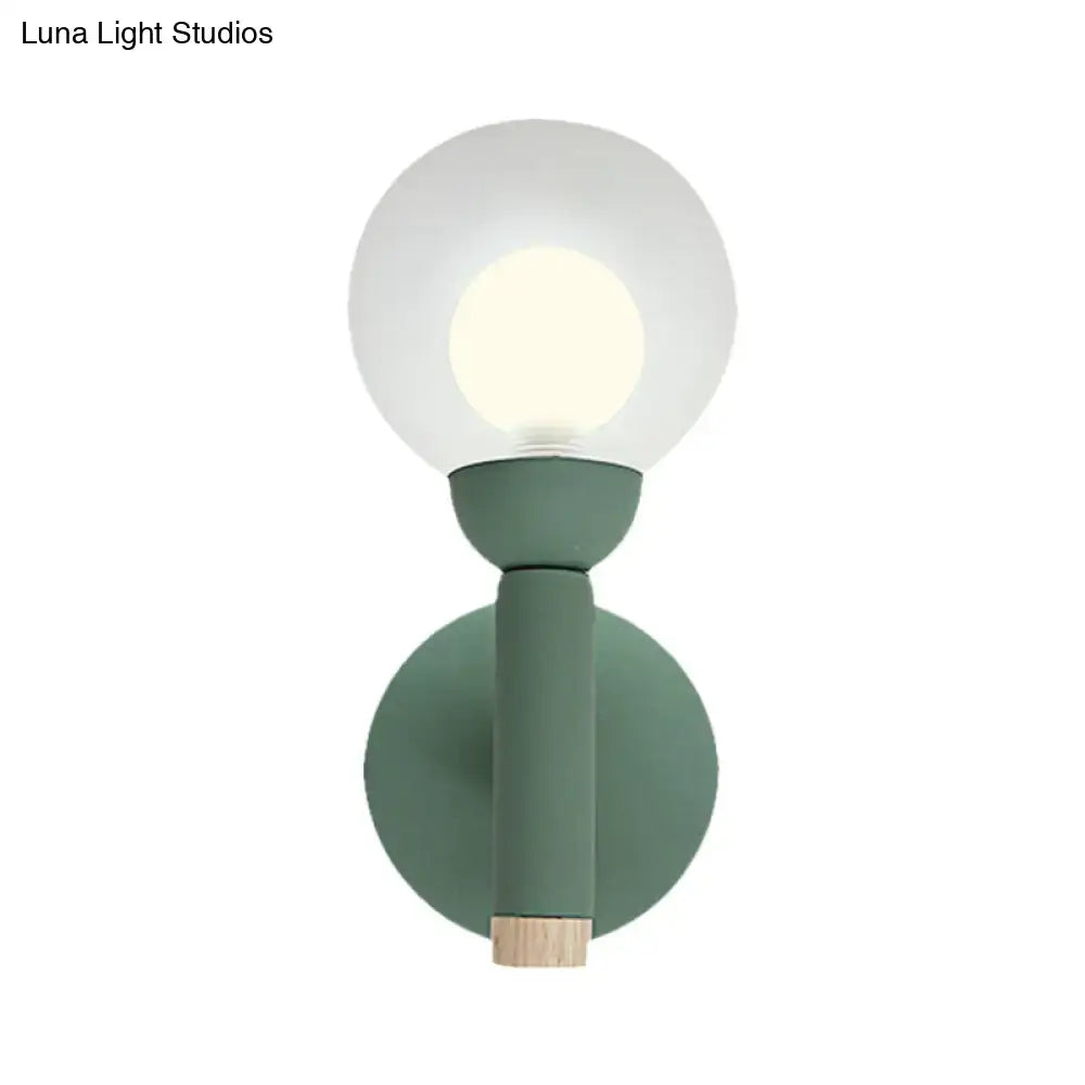 Sage Macaron Wall Sconce by Decorbites, sage green metal mount with glass globe and wood base on Tampa Home & Garden Store