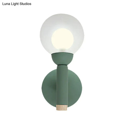Sage Macaron Wall Sconce by Decorbites, sage green metal mount with glass globe and wood base on Tampa Home & Garden Store