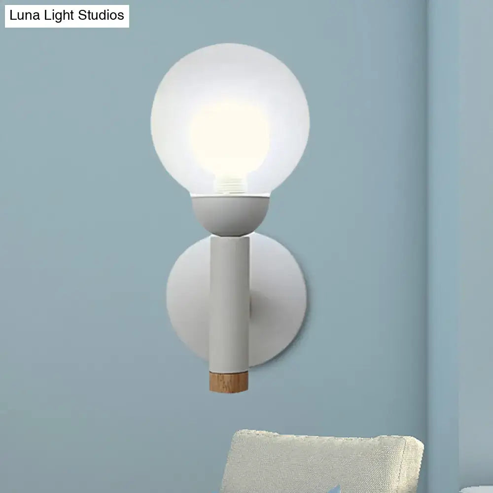 Sage Macaron Wall Sconce by Decorbites with white glass globe and wood accent on backplate on Tampa Home & Garden Store