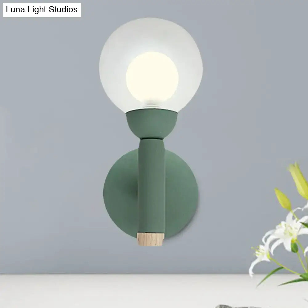 Sage Macaron Wall Sconce by Decorbites in sage green with round backplate and glass globe on Tampa Home & Garden Store
