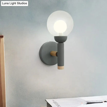 Sage Macaron Wall Sconce by Decorbites with gray metal arm, wood end cap, and glass globe on Tampa Home & Garden Store