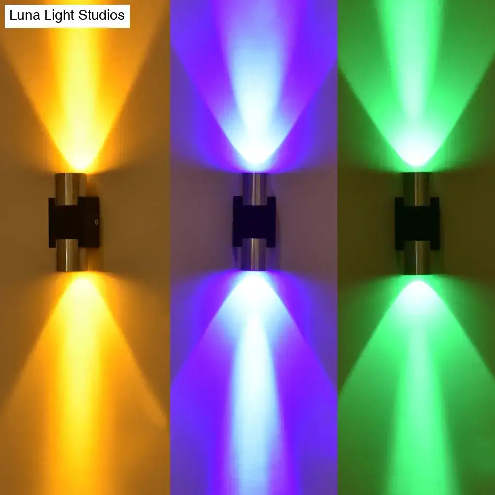 Silver aluminum wall lights by Decorbites with yellow, blue and green uplights on Tampa Home & Garden Store
