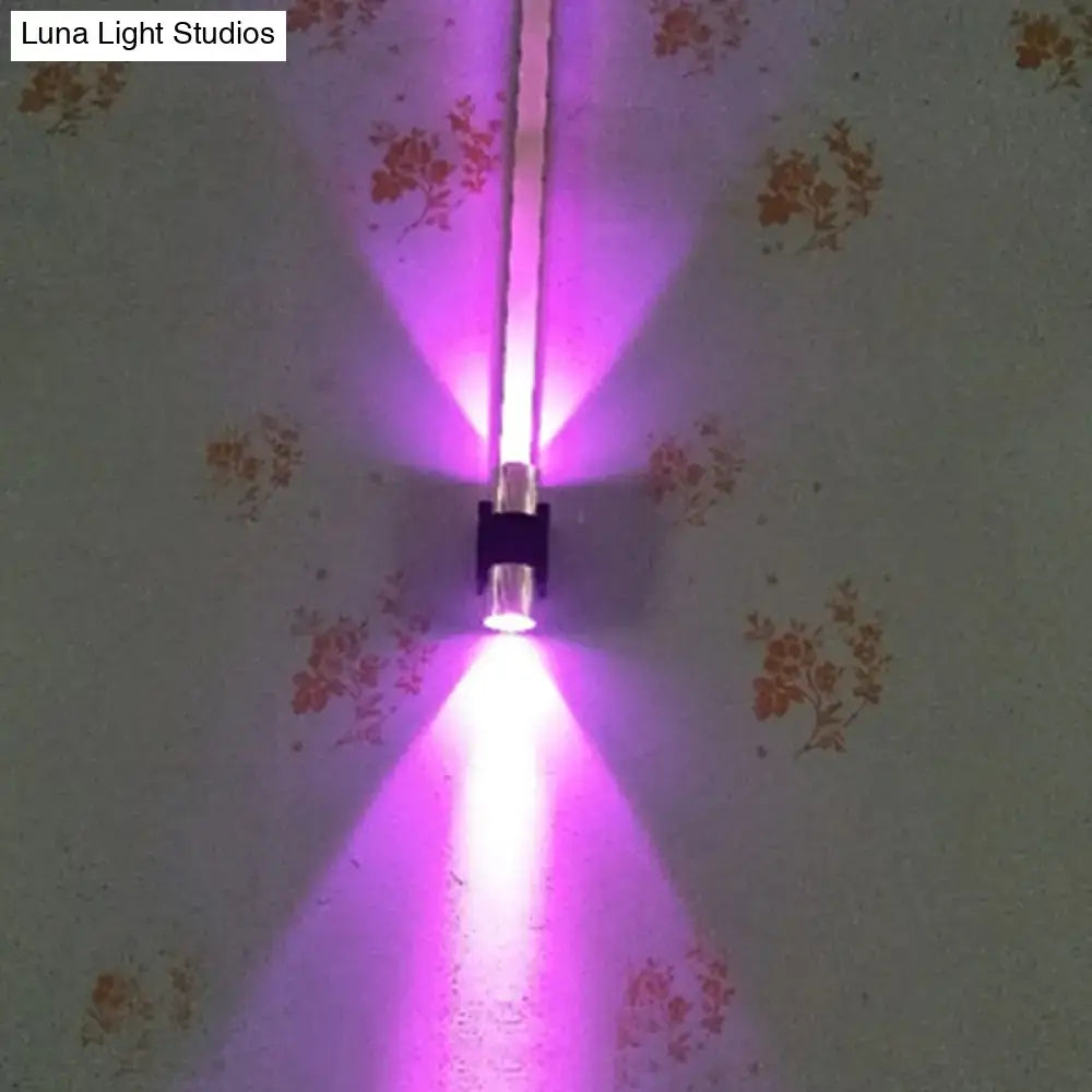 Silver aluminum wall light with LED tubes casting purple uplight and downlight on wall on Tampa Home & Garden Store