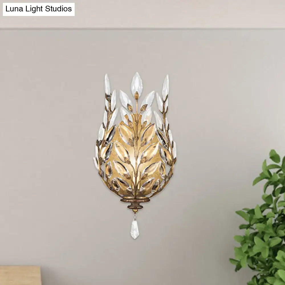 Brass crystal wall light with leaf-shaped petal design and dangling teardrop prism on Tampa Home & Garden Store