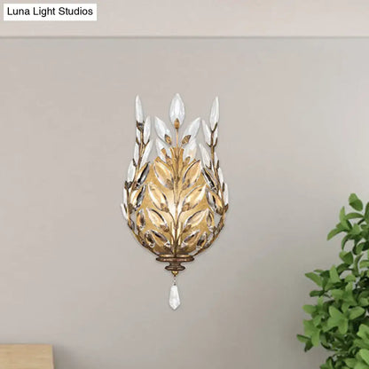 Brass crystal wall light with leaf-shaped petal design and dangling teardrop prism on Tampa Home & Garden Store