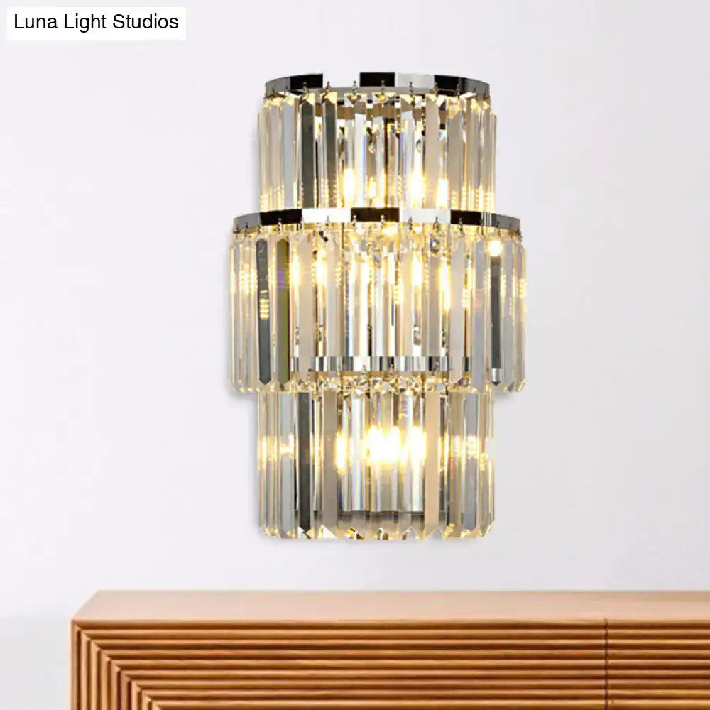 Silver crystal wall sconce with two-tier stacked prisms and warm glow on Tampa Home & Garden Store
