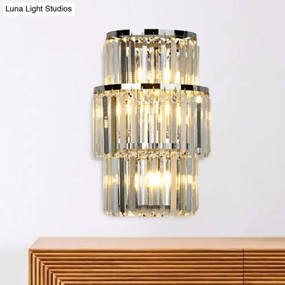 Silver crystal wall sconce with two-tier stacked prisms and warm glow on Tampa Home & Garden Store